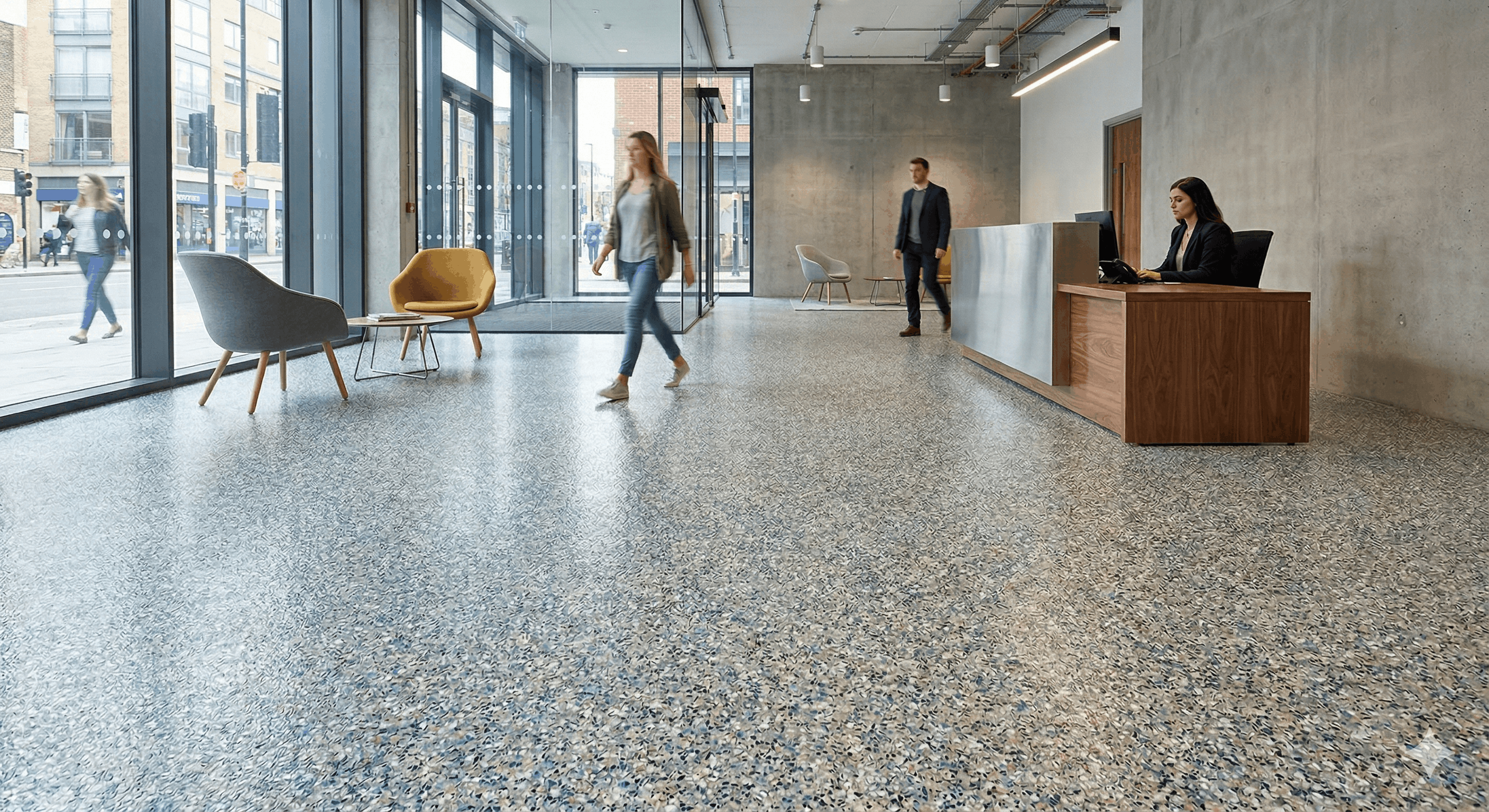 Quartz resin flooring in a modern commercial reception area with high foot traffic and seating, demonstrating a durable, slip-resistant surface finish.